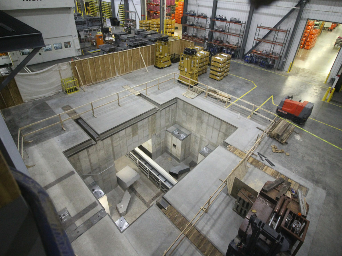 A press pit in an industrial warehouse.